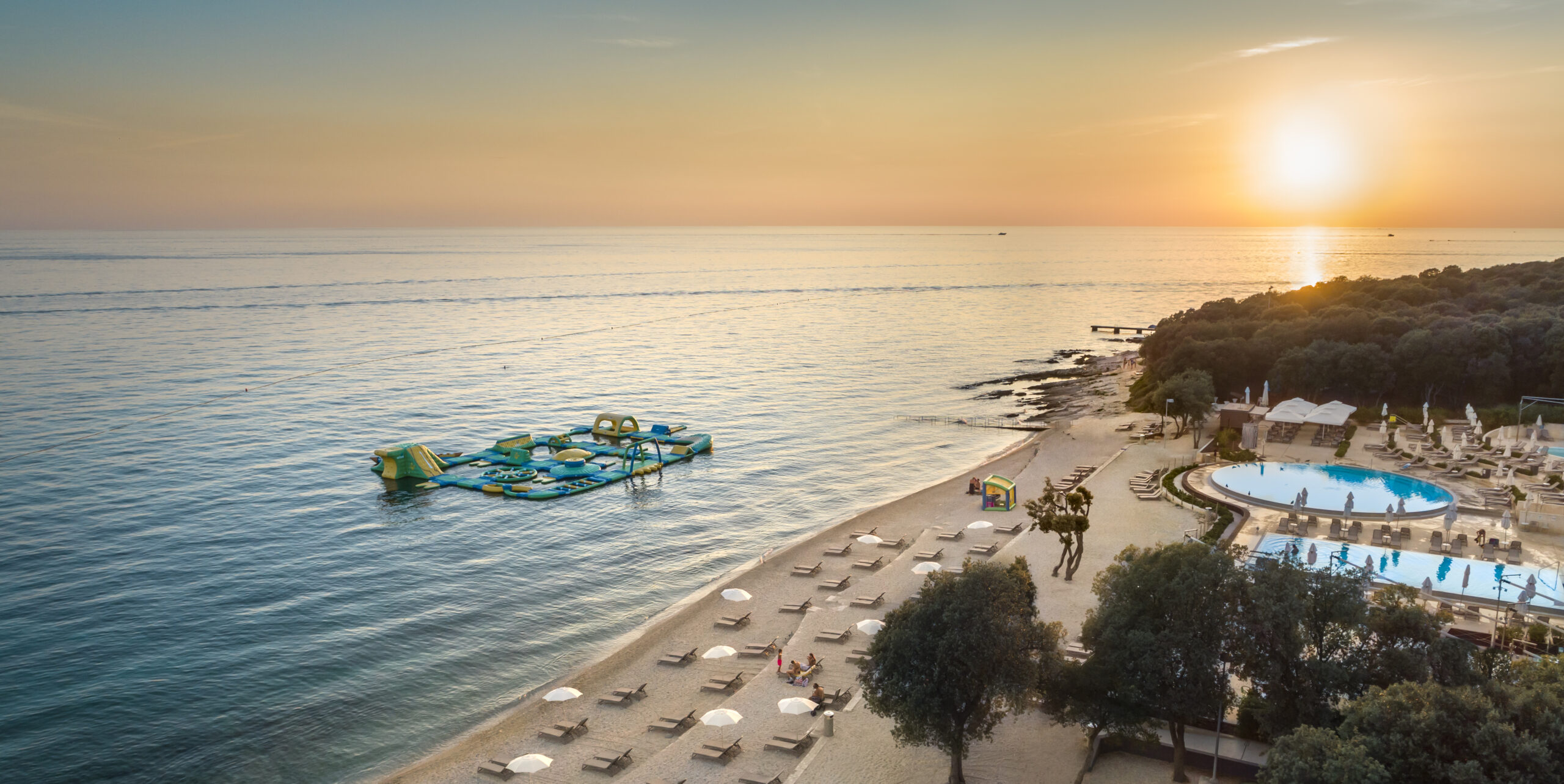 Campsite-Amarin-pebble-beach-pool-sunset
